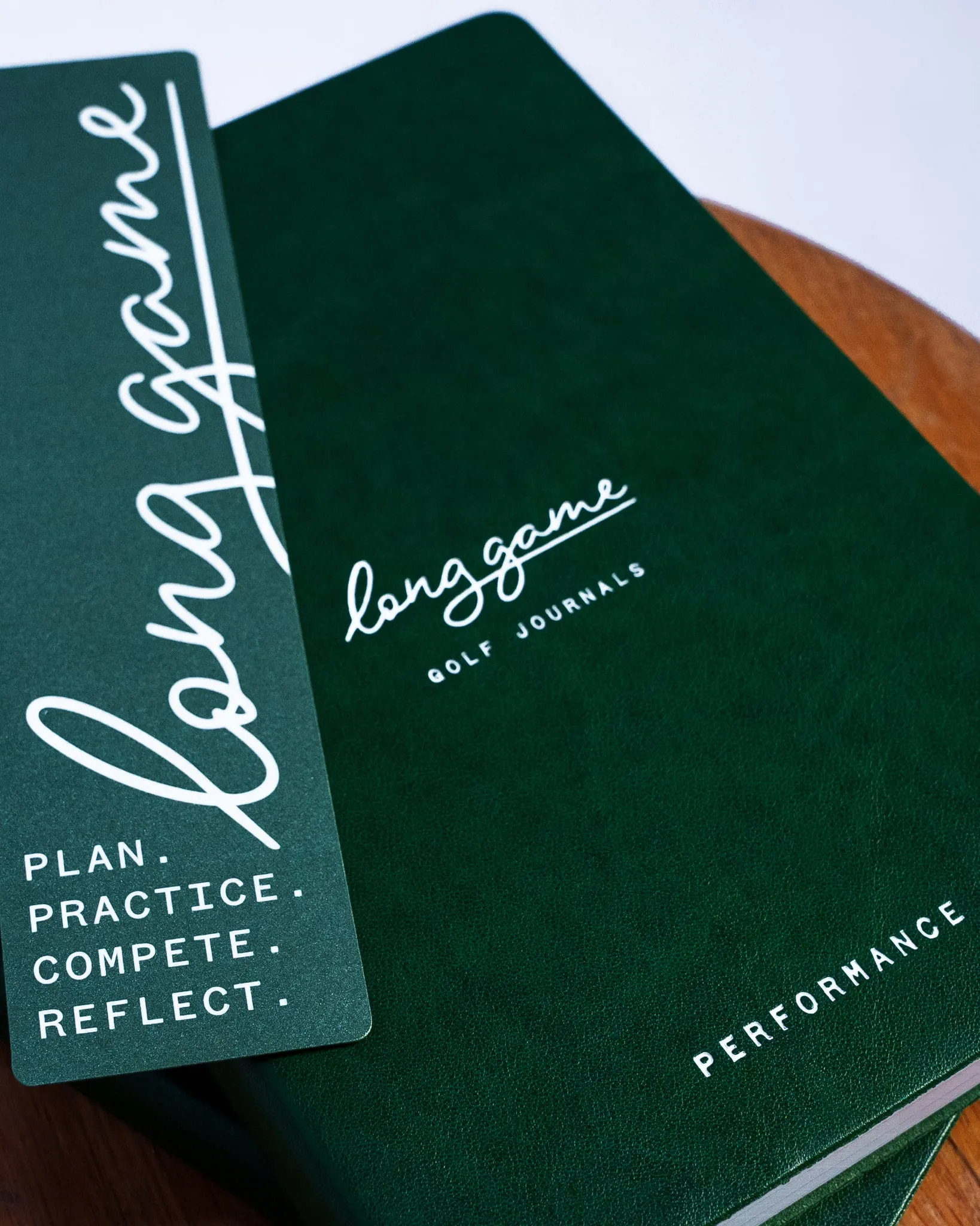 The Performance Journal, green cover with the Long Game bookmark