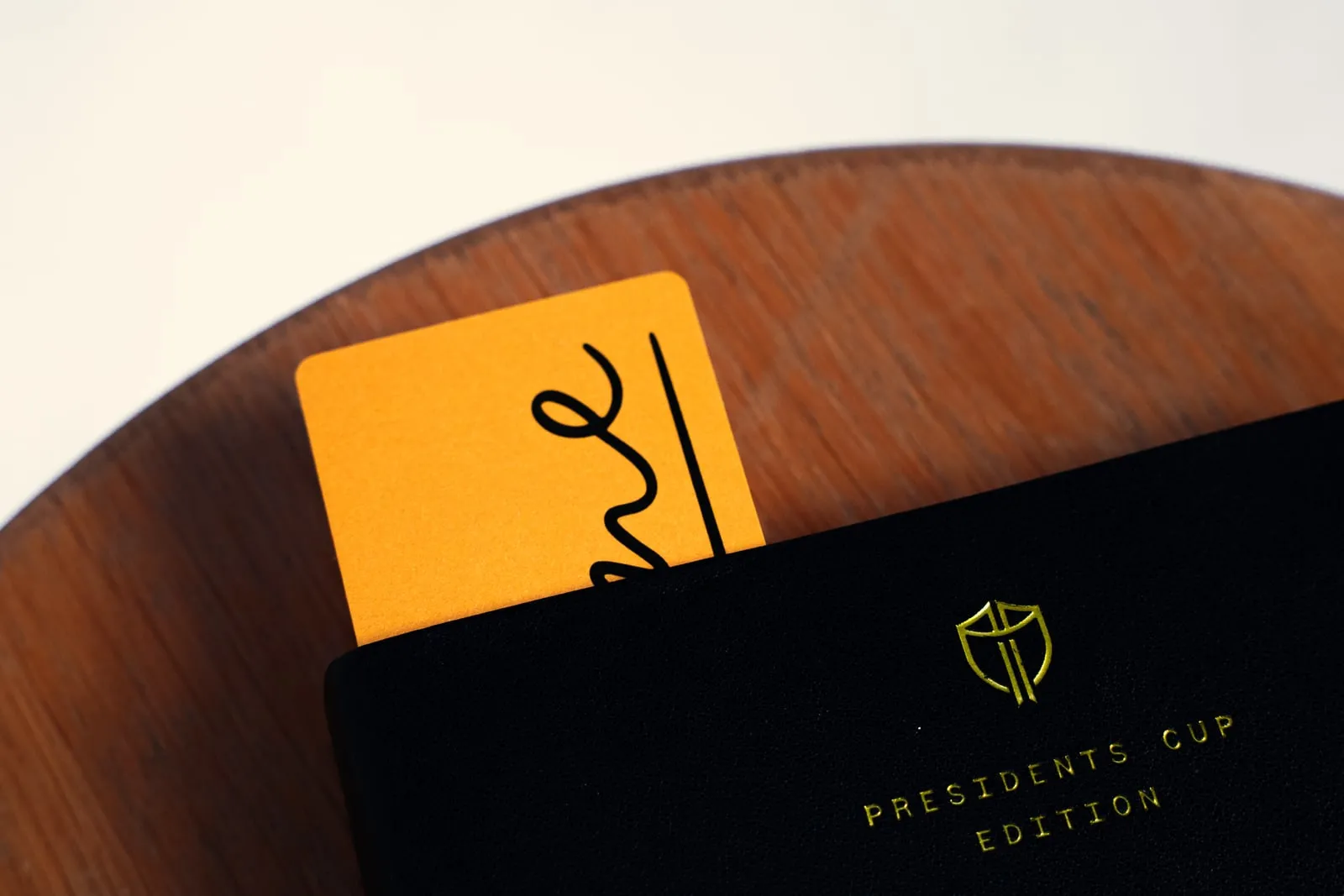 The bookmark tucked into a journal, with the crest visible on the cover